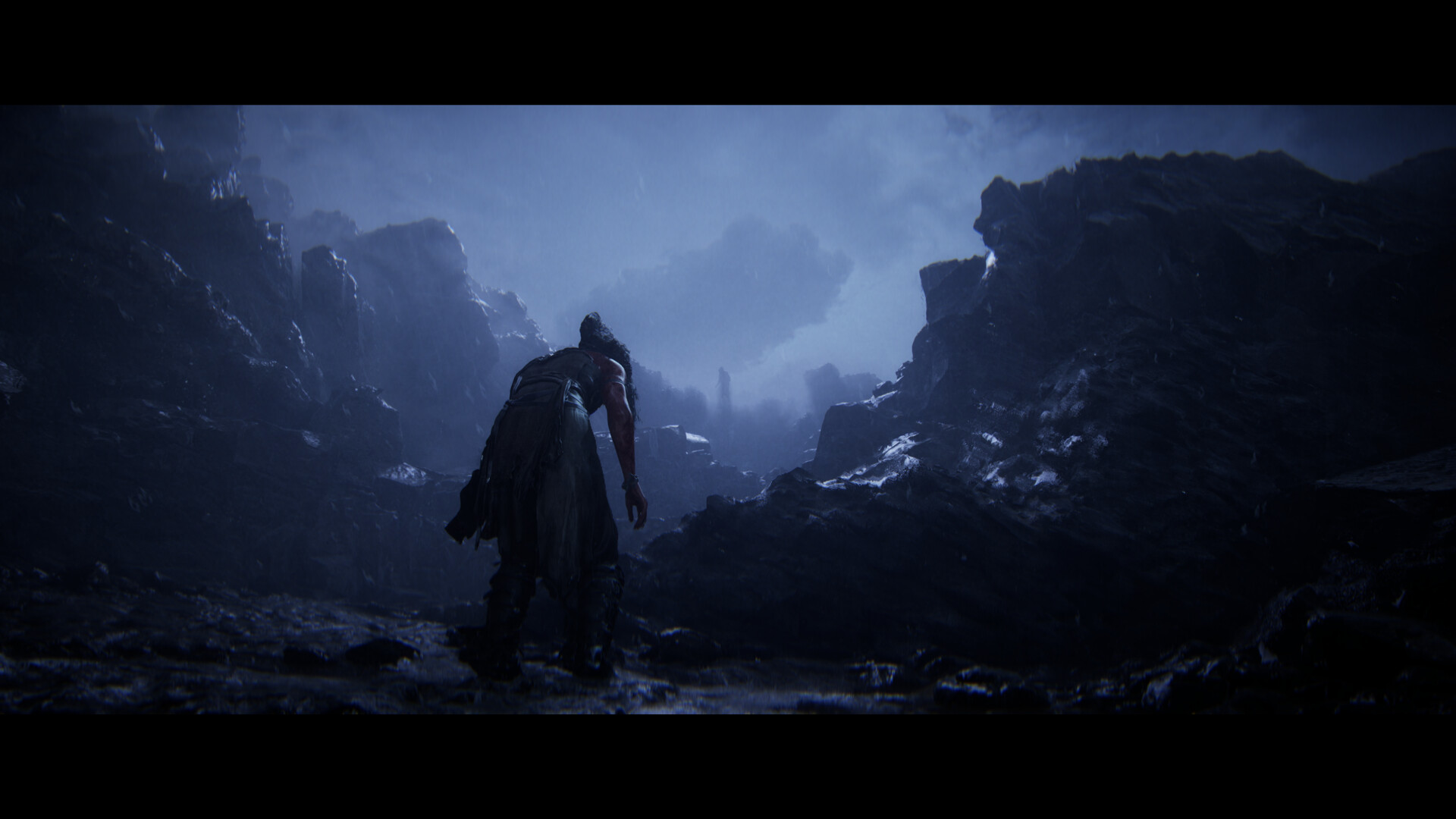 Senua dwarfed by a stark, windswept Icelandic landscape