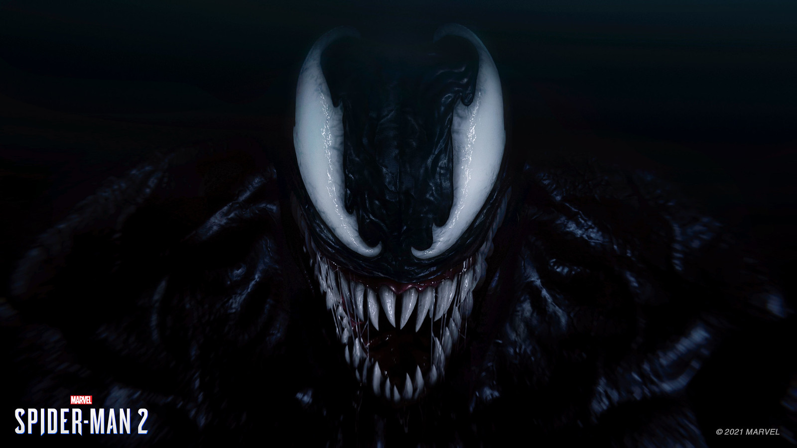 Venom grinning towards the camera surrounded by total darkness