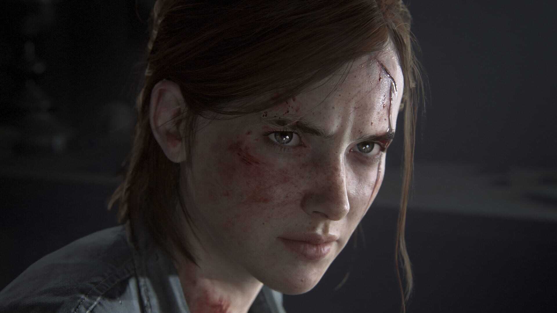 A bruised Ellie staring ahead in close-up