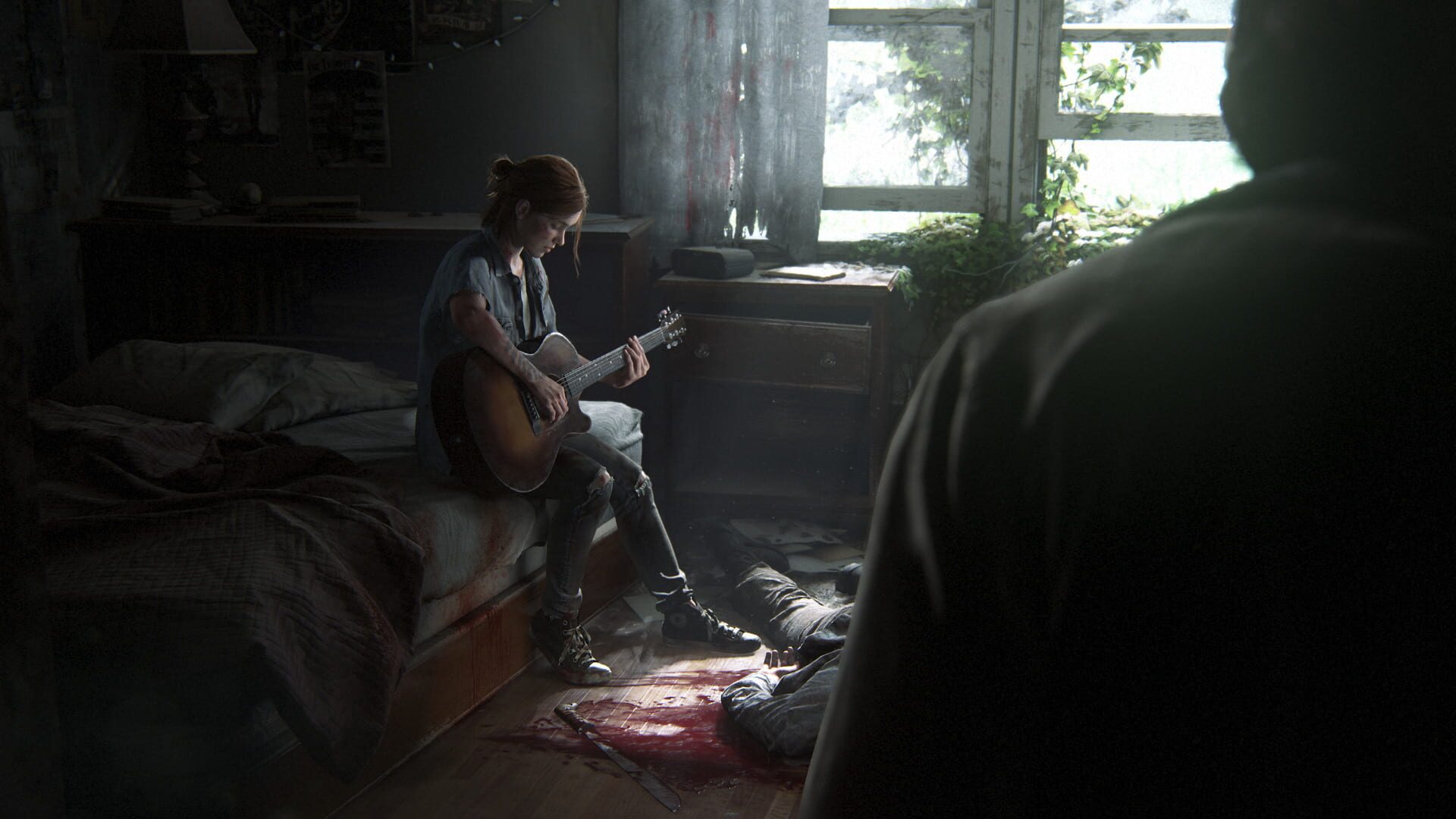 Ellie playing guitar on a bloodstained bed while a figure watches from the doorway